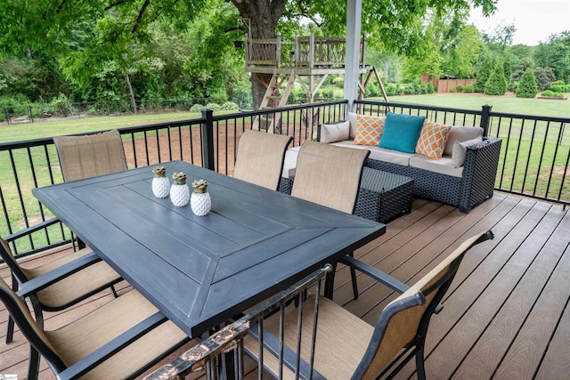 wooden deck featuring view of scattered trees and an outdoor hangout area