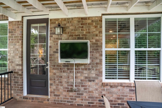 view of exterior entry with brick siding
