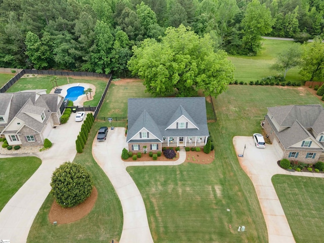 aerial view of property and surrounding area featuring a pool area
