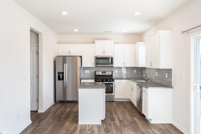 737 Rockhurst Way, Woodruff, SC 29388 - kitchen with appliances with stainless steel finishes, a center island, dark wood finished floors, light stone counters, and recessed lighting