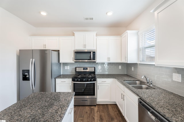 737 Rockhurst Way, Woodruff, SC 29388 - kitchen featuring appliances with stainless steel finishes, a sink, dark stone countertops, white cabinetry, and recessed lighting