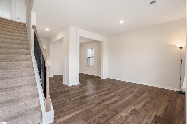 737 Rockhurst Way, Woodruff, SC 29388 - unfurnished living room featuring dark wood-style flooring, stairway, baseboards, and recessed lighting