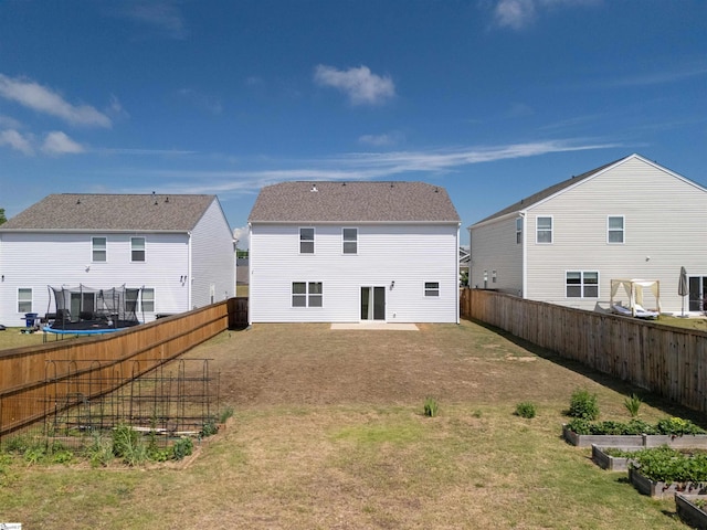 737 Rockhurst Way, Woodruff, SC 29388 - back of house featuring a vegetable garden and a trampoline