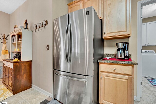 5 Laurelcrest Ln, Travelers Rest, SC 29690 - kitchen with freestanding refrigerator, washer / clothes dryer, light tile patterned floors, light brown cabinets, and baseboards