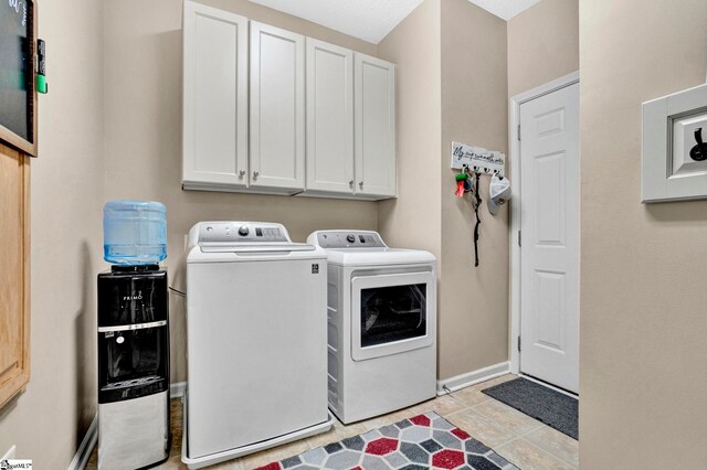 5 Laurelcrest Ln, Travelers Rest, SC 29690 - laundry area featuring cabinet space, washing machine and dryer, baseboards, and light tile patterned floors