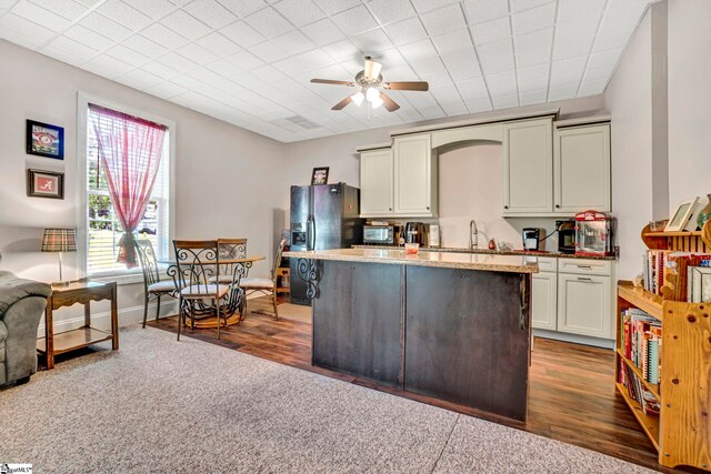 5 Laurelcrest Ln, Travelers Rest, SC 29690 - kitchen featuring a ceiling fan, a kitchen island, black fridge, dark wood-type flooring, and a sink