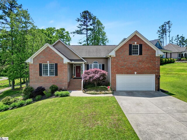 5 Laurelcrest Ln, Travelers Rest, SC 29690 - view of front of house featuring brick siding, a garage, concrete driveway, and a front lawn