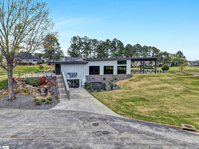 5 Laurelcrest Ln, Travelers Rest, SC 29690 - view of front of house featuring stairway, a front yard, concrete driveway, and stone siding