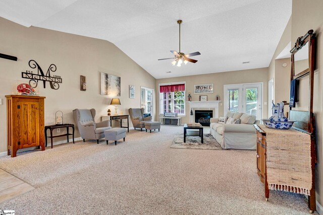 5 Laurelcrest Ln, Travelers Rest, SC 29690 - carpeted living area featuring vaulted ceiling, a ceiling fan, a glass covered fireplace, and baseboards