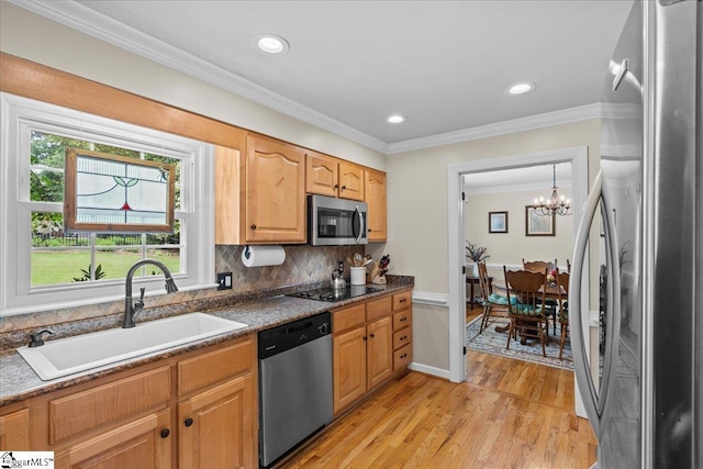 kitchen with appliances with stainless steel finishes, a sink, plenty of natural light, a chandelier, and recessed lighting