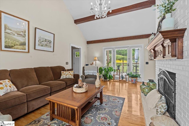 living area featuring a fireplace, beamed ceiling, a chandelier, wood finished floors, and high vaulted ceiling