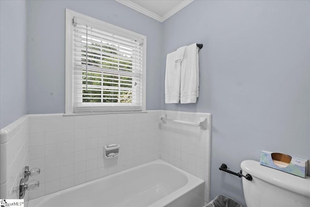 bathroom featuring crown molding, a bath, and toilet