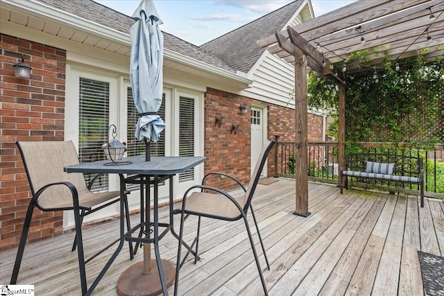 wooden deck featuring a pergola and outdoor dining area