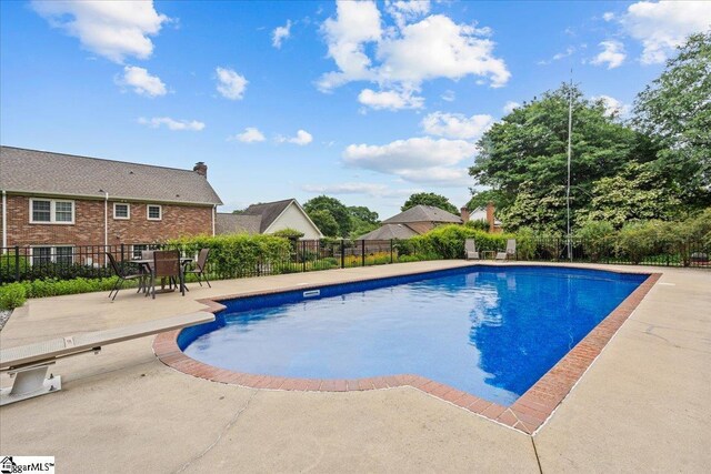 view of pool with fence and a patio area