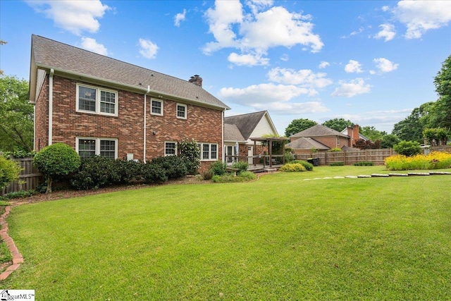 rear view of property with brick siding and a chimney