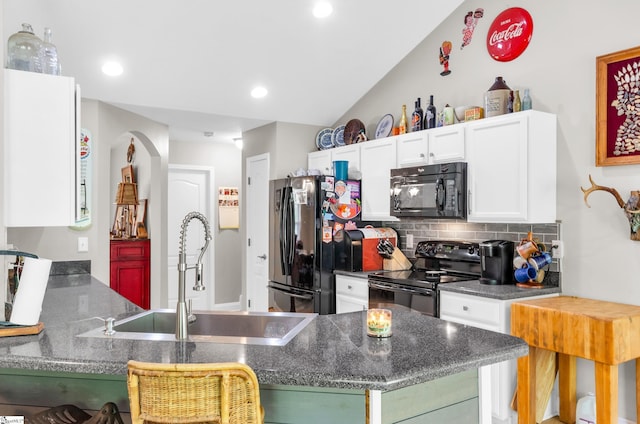 kitchen with black appliances, a sink, white cabinets, tasteful backsplash, and dark countertops