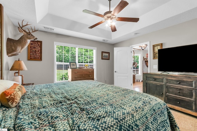 bedroom featuring a tray ceiling and ceiling fan