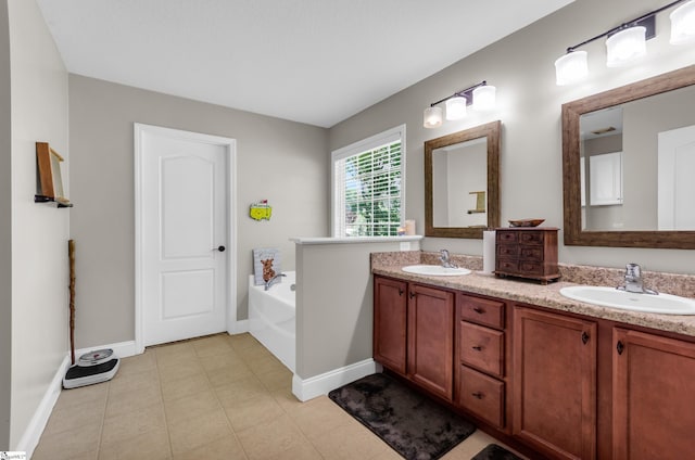 full bath featuring baseboards, a bath, double vanity, and tile patterned floors