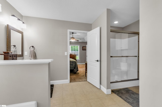 ensuite bathroom with a ceiling fan, baseboards, a shower stall, and recessed lighting