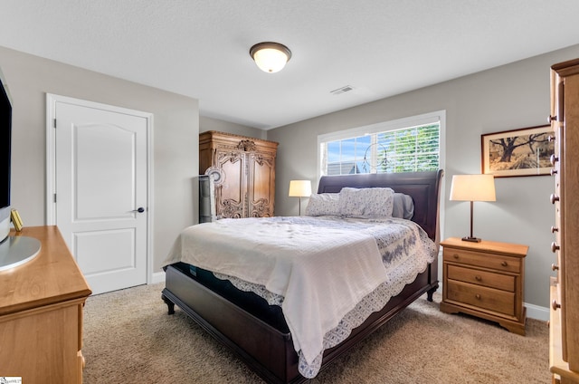 bedroom featuring light carpet and baseboards