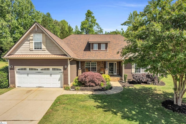 view of front of property featuring a front yard, concrete driveway, a porch, roof with shingles, and an attached garage