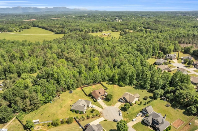 aerial view of property's location with a heavily wooded area