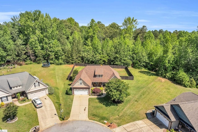 aerial view of property and surrounding area featuring a heavily wooded area