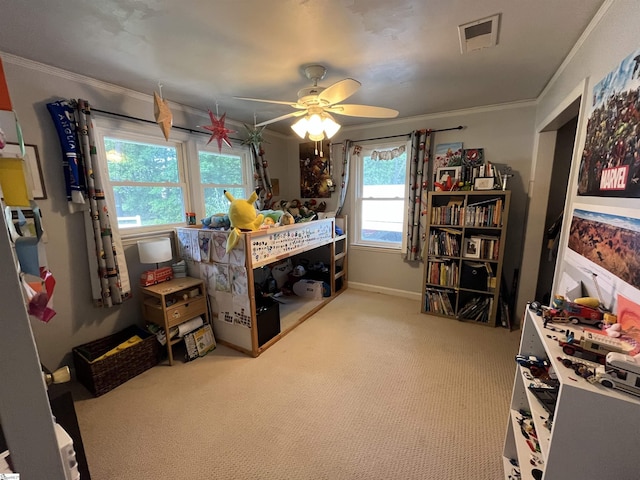 bedroom featuring carpet floors, crown molding, a ceiling fan, and baseboards