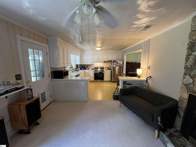kitchen with stainless steel appliances, under cabinet range hood, ceiling fan, light colored carpet, and crown molding