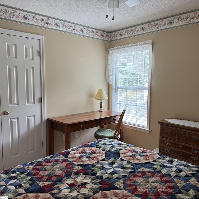bedroom featuring a textured ceiling and ceiling fan