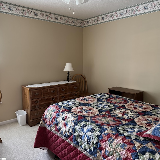 bedroom featuring light carpet and a ceiling fan