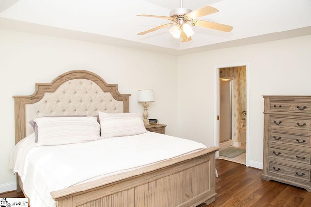 bedroom featuring dark wood-type flooring, baseboards, a ceiling fan, and ensuite bathroom