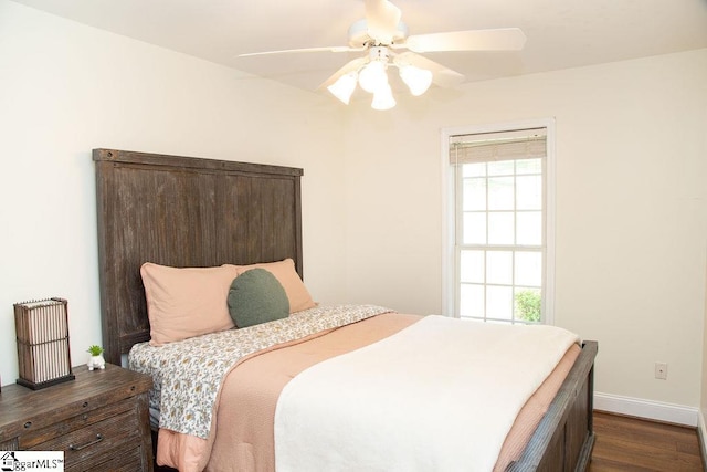 bedroom with dark wood finished floors, baseboards, and ceiling fan