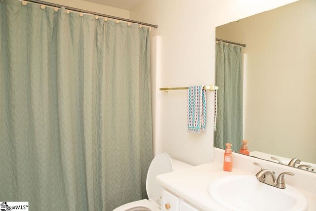 bathroom featuring toilet and vanity