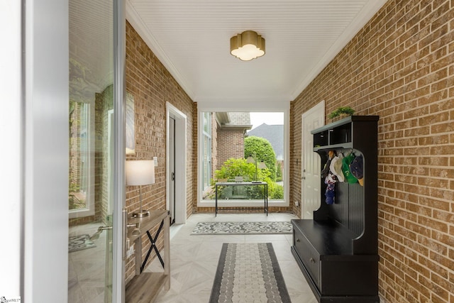 mudroom with brick wall and crown molding