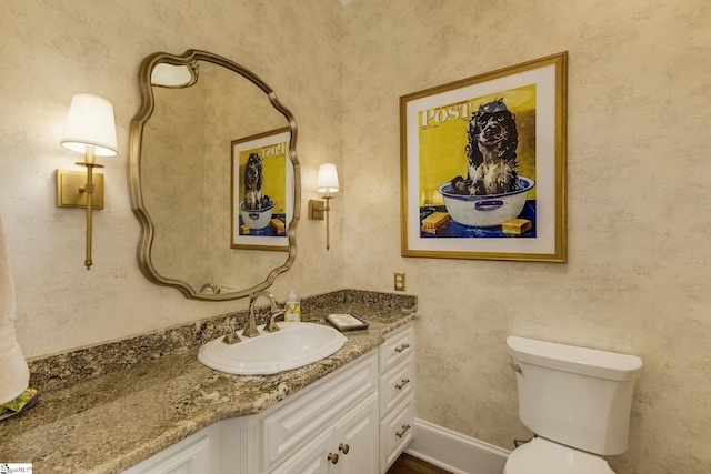 bathroom featuring vanity and toilet
