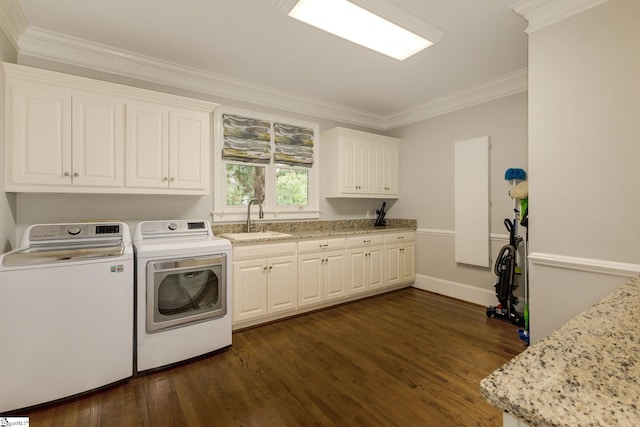 laundry area featuring cabinet space, washer and dryer, dark wood-style flooring, crown molding, and baseboards