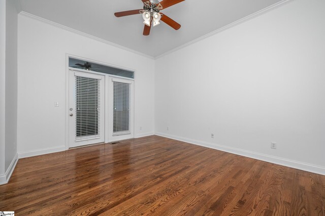 spare room with a ceiling fan, baseboards, wood finished floors, and crown molding
