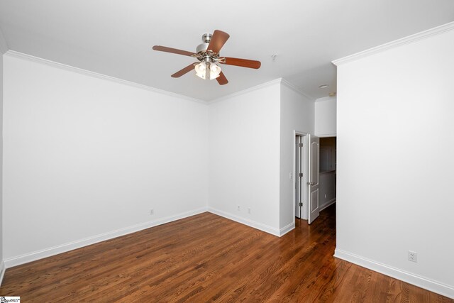 unfurnished room with wood finished floors, crown molding, baseboards, and ceiling fan