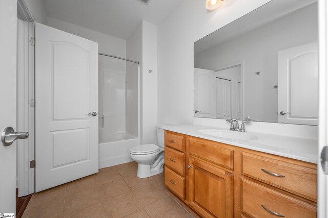 bathroom featuring tile patterned floors, vanity, toilet, and washtub / shower combination