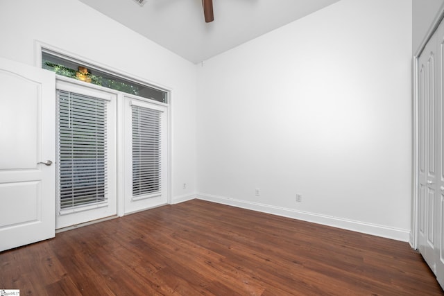 unfurnished bedroom featuring wood finished floors, baseboards, ceiling fan, and access to exterior