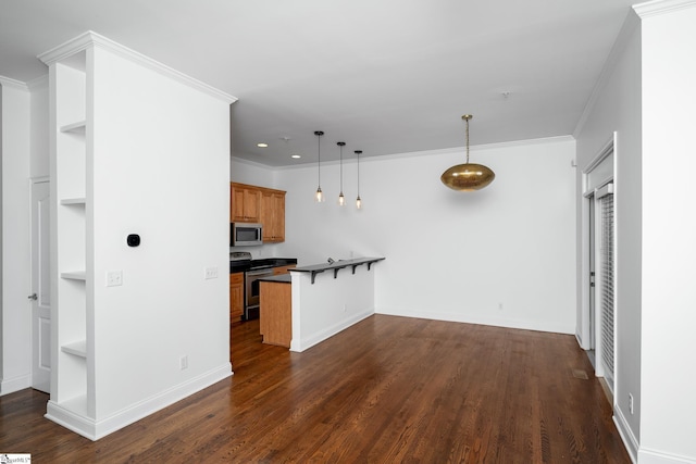 kitchen featuring stainless steel appliances, a kitchen breakfast bar, dark countertops, built in features, and brown cabinetry
