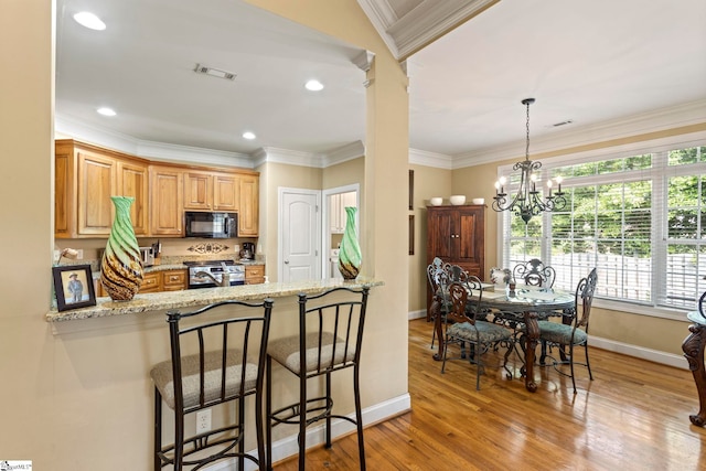 1008 Calumet Ct, Piedmont, SC 29673 - kitchen featuring black microwave, stainless steel range oven, baseboards, a chandelier, and ornamental molding