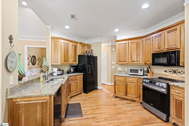 1008 Calumet Ct, Piedmont, SC 29673 - kitchen featuring black appliances, a sink, ornamental molding, light wood-style flooring, and light stone countertops