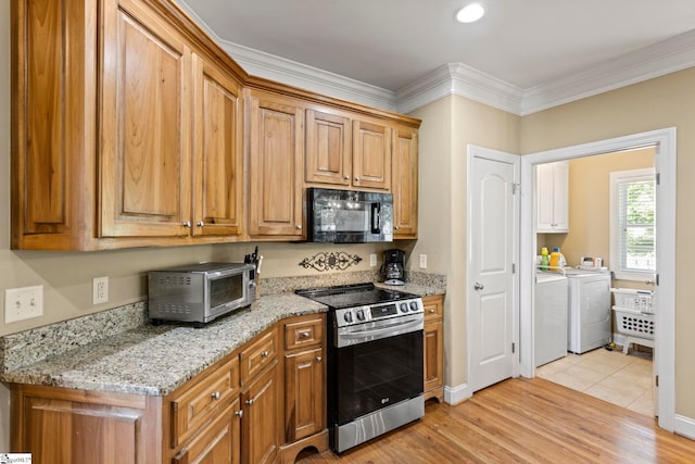 1008 Calumet Ct, Piedmont, SC 29673 - kitchen featuring black microwave, stainless steel electric range, washer and dryer, ornamental molding, and light wood-type flooring