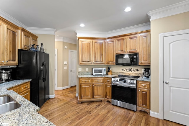 1008 Calumet Ct, Piedmont, SC 29673 - kitchen with black appliances, baseboards, light wood-type flooring, light stone counters, and crown molding