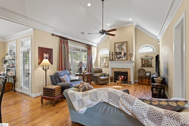 1008 Calumet Ct, Piedmont, SC 29673 - living room featuring light wood-style floors, baseboards, ornamental molding, a tile fireplace, and healthy amount of natural light