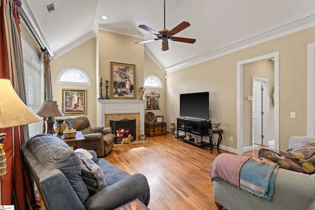 1008 Calumet Ct, Piedmont, SC 29673 - living room with crown molding, a ceiling fan, a tile fireplace, vaulted ceiling, and plenty of natural light