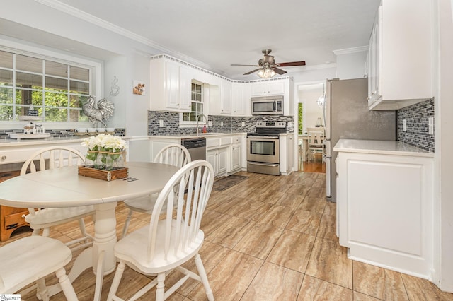 108 Ascot Ct, Easley, SC 29642 - kitchen with appliances with stainless steel finishes, backsplash, ceiling fan, and crown molding
