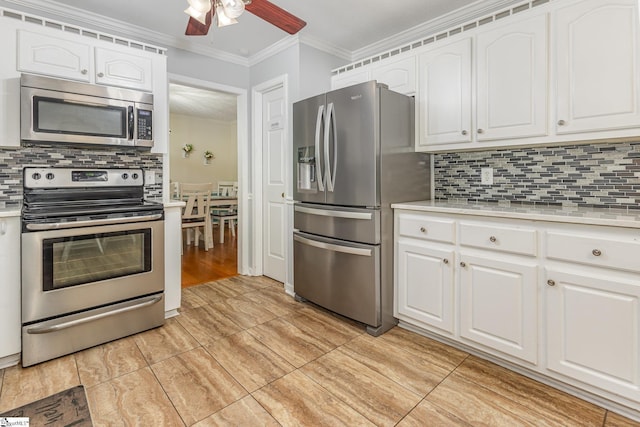 108 Ascot Ct, Easley, SC 29642 - kitchen featuring stainless steel appliances, light countertops, crown molding, and white cabinetry